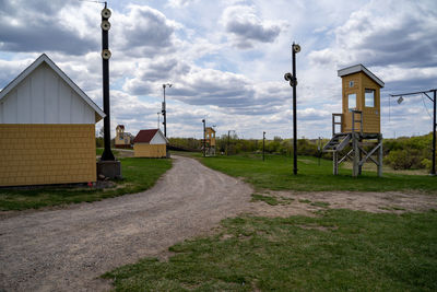 Street amidst houses and buildings against sky