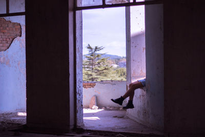 Side view of man on window