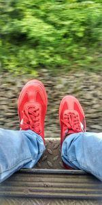 Low section of person wearing red shoes