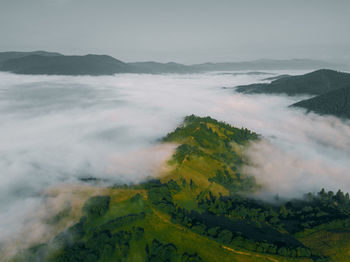 Sea of clouds and picturesque mountains above. beautiful carpathians at early winter or autumn 