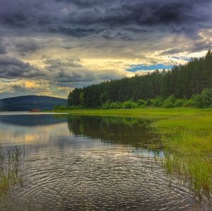 Scenic view of lake against cloudy sky