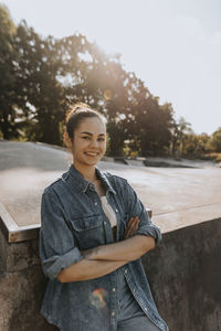 Smiling teenage girl looking at skate park looking at camera