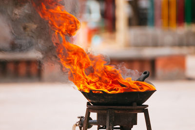 Close-up of fire burning on wood