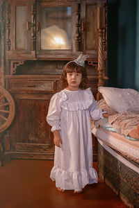 Portrait of of girl wearing crown at home