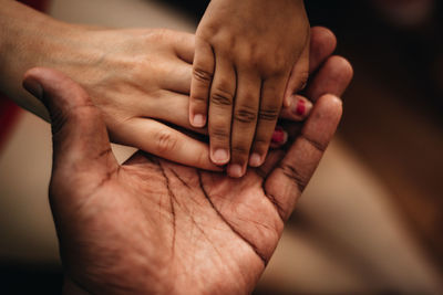 Close-up of stacked hands outdoors