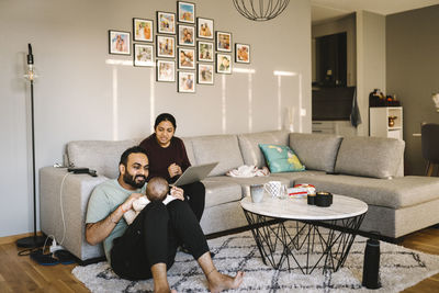 Father and mother with baby in living room