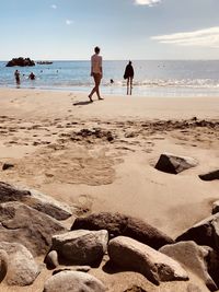 People on beach against sky