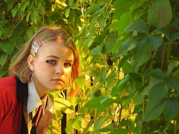 Portrait of young woman with leaves