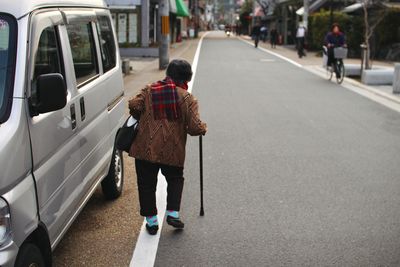 An old woman walking in the streets of kyoto, japan