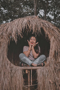 Portrait of smiling young woman sitting outdoors