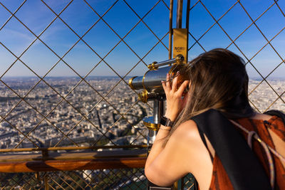 Rear view of woman looking at sea against sky