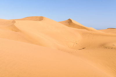 Scenic view of desert against clear sky