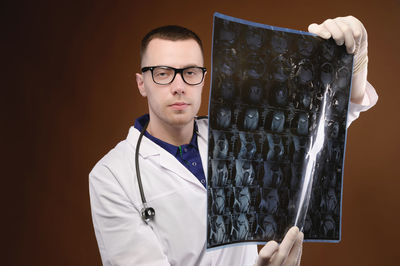 Mid section of man holding eyeglasses