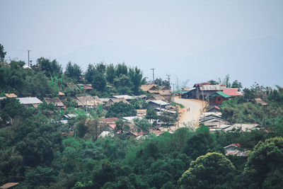 High angle view of buildings in town against clear sky