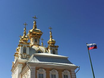 Low angle view of built structure against clear blue sky