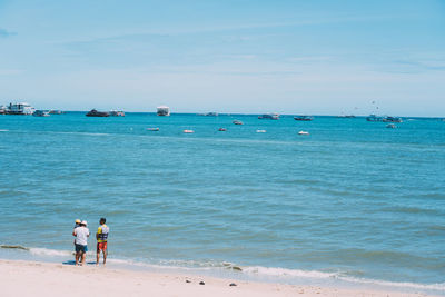 People standing on shore at beach