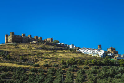 Low angle view of castle against clear blue sky