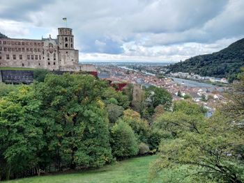 Panoramic view of trees and buildings against sky