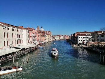 Boats in canal in city