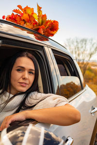 Portrait of smiling woman in car