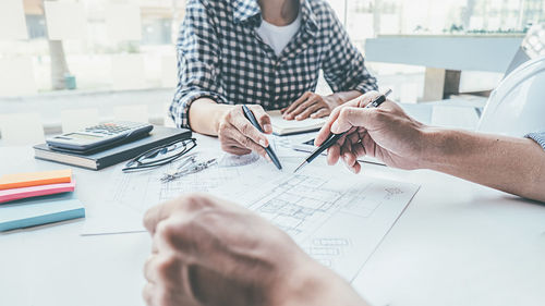 Low section of people working on table