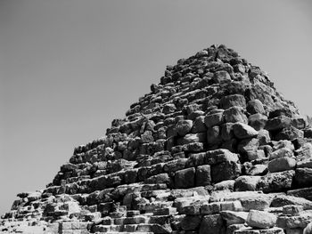 Low angle view of rock formation against clear sky