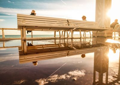 Built structure by sea against sky