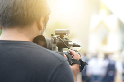 Rear view of man photographing