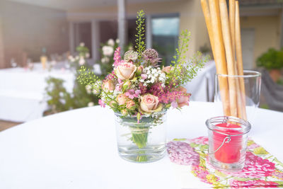 Flowers in glass vase on table for summer party