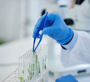 Cropped hand of scientist examining chemical in laboratory