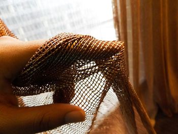 Cropped image of woman's hand touching material