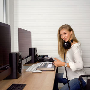 Portrait of a smiling young woman on table