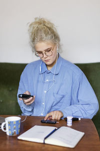 Young woman using glucometer