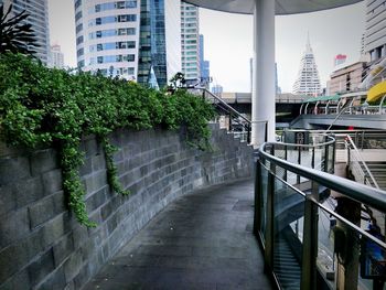 Footpath amidst buildings in city