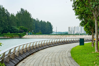Footpath by river against sky