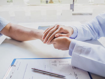 Doctor consoling patient at hospital