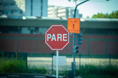 Road sign against buildings in city