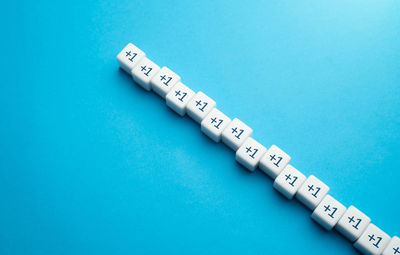 Close-up of thermometer on blue background