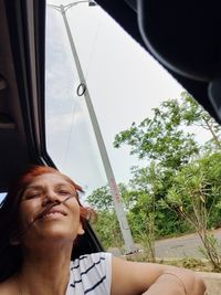 Portrait of smiling woman in car