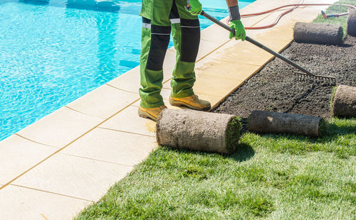 Low section of person by swimming pool