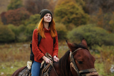 Young man riding horse