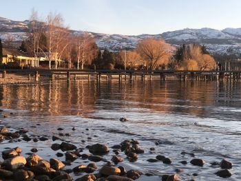 Scenic view of lake against sky during winter