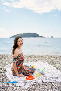 Young woman sitting on beach