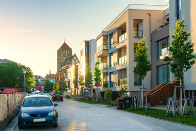 Cars on road amidst buildings against sky