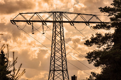 Low angle view of electricity pylon against sky