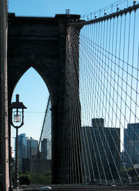 Low angle view of suspension bridge against sky