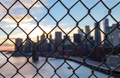 Close-up of chainlink fence against sky