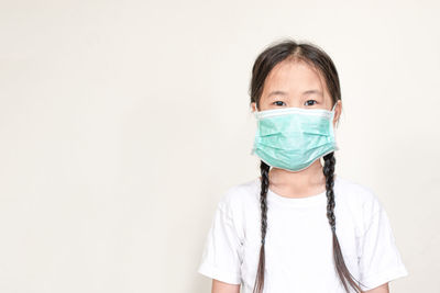 Portrait of girl wearing hat against white background