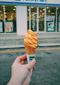 Hand holding ice cream cone