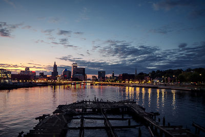 View of buildings at waterfront during sunset